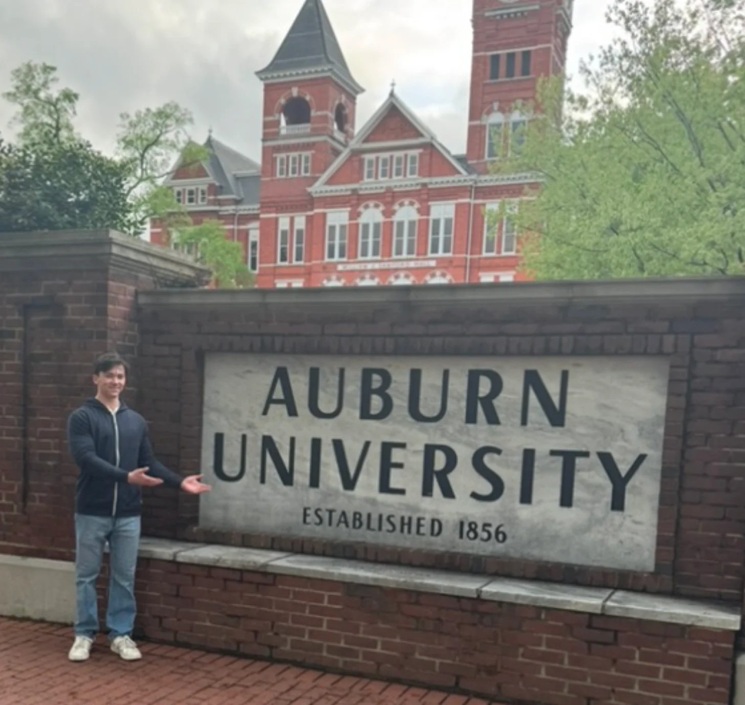 Oliver at the Auburn University sign